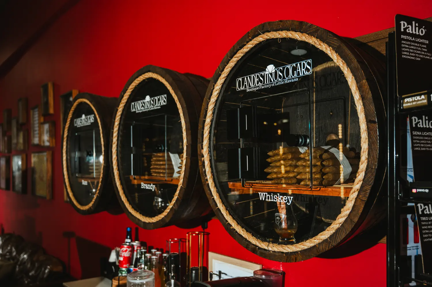 Barrel-shaped display cases with the Clandestinos Cigars logo