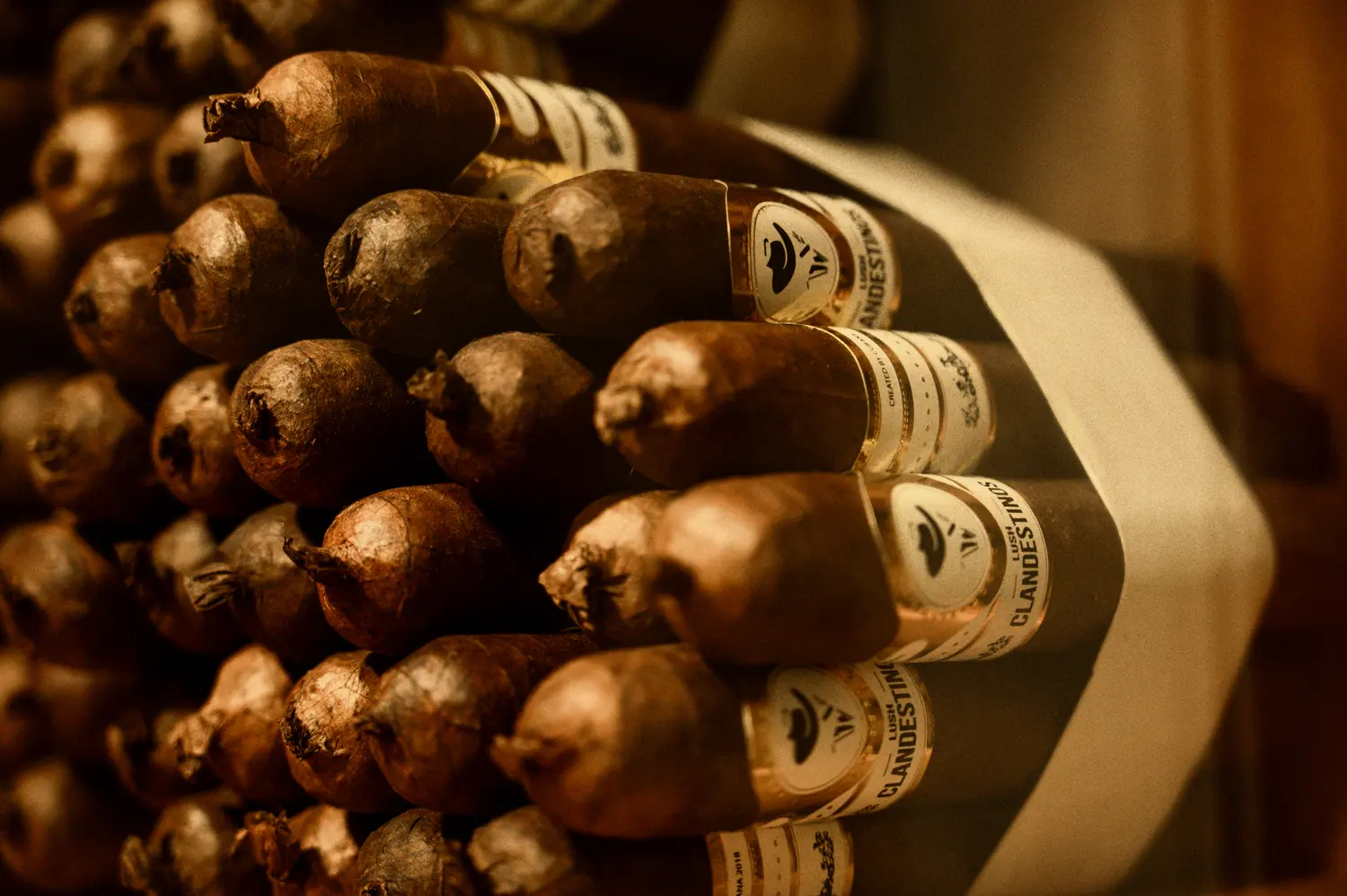Stacked Clandestinos cigars with their bands